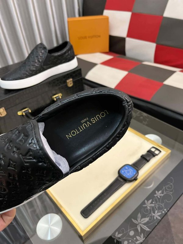 blackleatherLouisVuittonslip-onsneakerwithawhitesole_3 LV Black Monogram Embossed Leather Slip-On Trainers