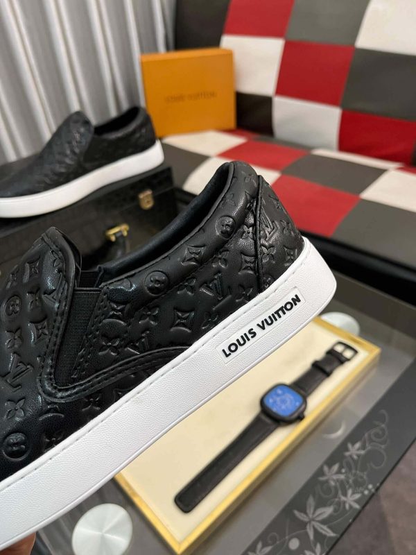 blackleatherLouisVuittonslip-onsneakerwithawhitesole_4 LV Black Monogram Embossed Leather Slip-On Trainers
