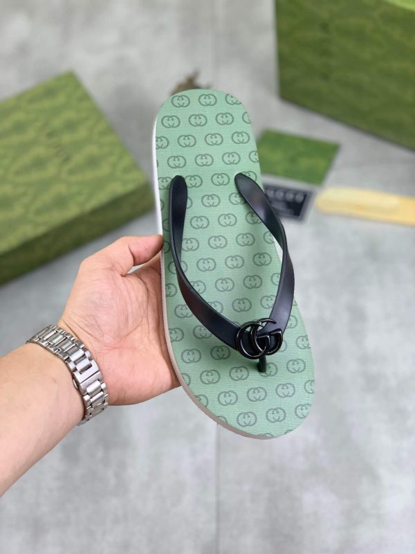 lightgreensoleadornedwiththeiconicinterlockingGGlogopatternandblackstrapswithaprominentGGemblematthecenter_1 Gucci Green Interlocking Jacquard Thong Sandals with Double G
