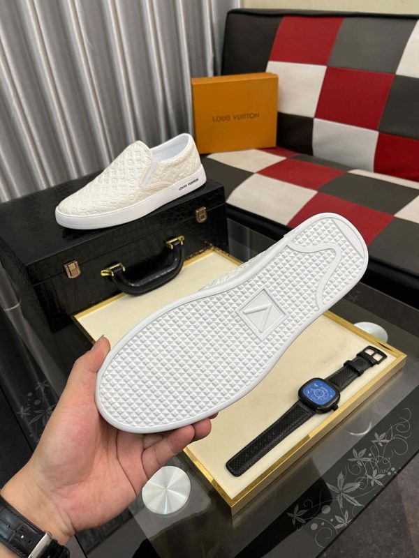 whiteLouisVuittonslip-onsneakerwiththebrand_smonogrampatternembossedacrosstheupper_3 LV Men's White Monogram Embossed Leather Slip-On Trainers