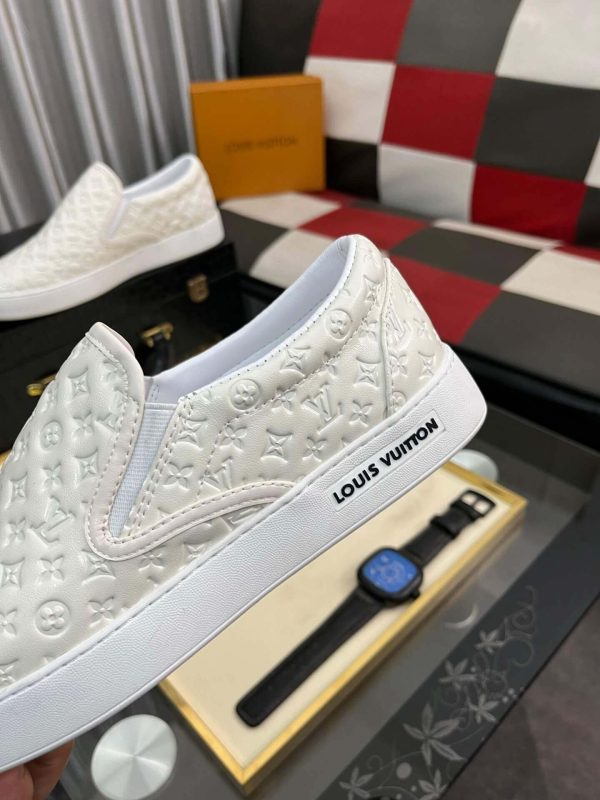 whiteLouisVuittonslip-onsneakerwiththebrand_smonogrampatternembossedacrosstheupper_4 LV Men's White Monogram Embossed Leather Slip-On Trainers