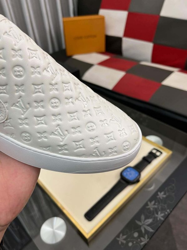 whiteLouisVuittonslip-onsneakerwiththebrand_smonogrampatternembossedacrosstheupper_5 LV Men's White Monogram Embossed Leather Slip-On Trainers