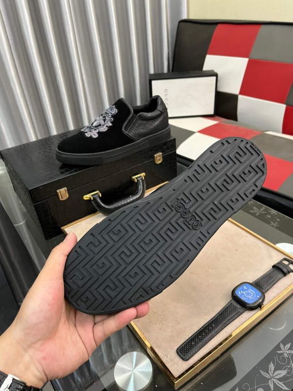 Gucci Men's Slip-On Loafers with An Embellished Crest Design.