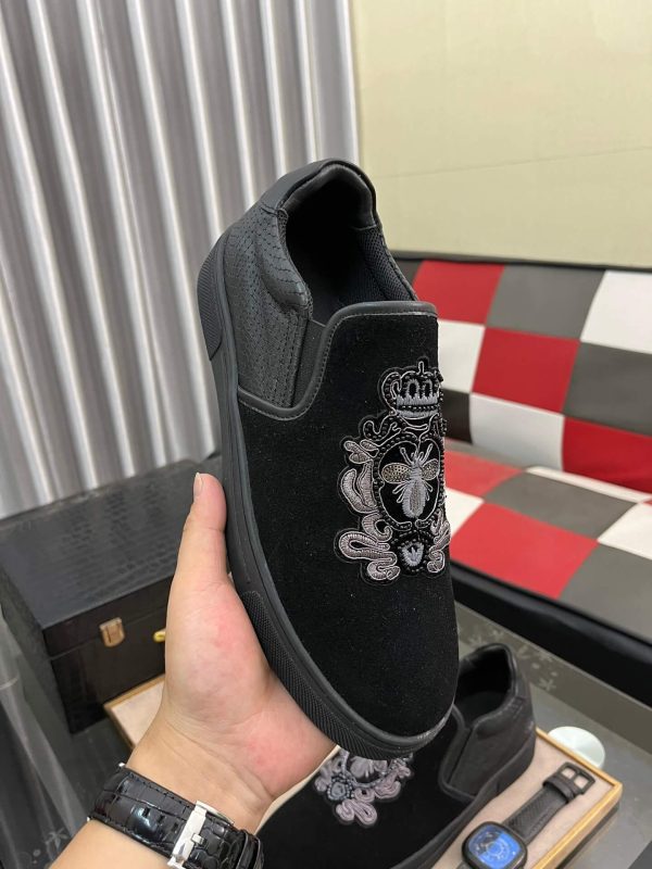 Gucci Men's Slip-On Loafers with An Embellished Crest Design.