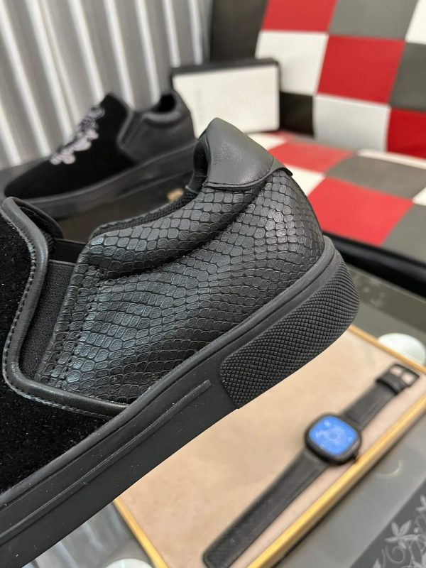 Gucci Men's Slip-On Loafers with An Embellished Crest Design.