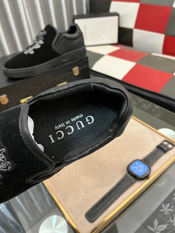 Gucci Men's Slip-On Loafers with An Embellished Crest Design.