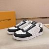 LOUIS VUITTON Rivoli Sneaker in White Monogram Debossed Leather and Black Smooth Leather