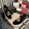 Gucci Men's Slip-On Loafers with A Gold Embellished Crest Design