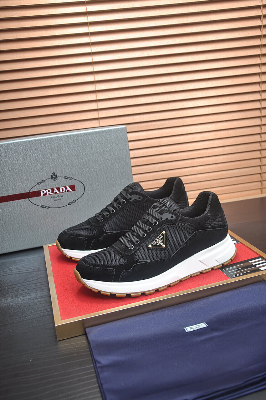 Prada Prax 2.0 Re-Nylon and Suede Sneaker in a black and white colorway. 1 Prada Prax 2.0 Re-Nylon and Suede Sneaker in a black and white colorway.