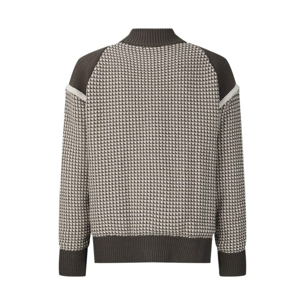 The jacket is brown and beige with a houndstooth-like pattern across the main body, and has solid, dark brown sleeves with a different knit texture