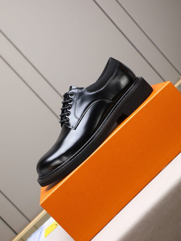 Louis Vuitton black leather lace-up derby shoes.