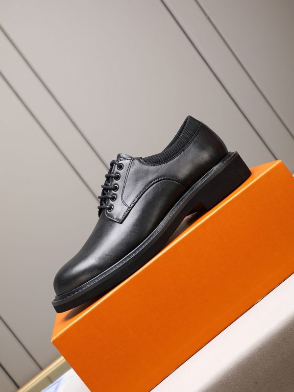 Louis Vuitton black leather lace-up derby shoes.