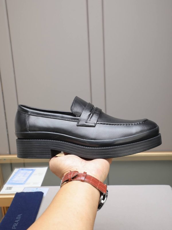 black Prada brushed leather loafers.