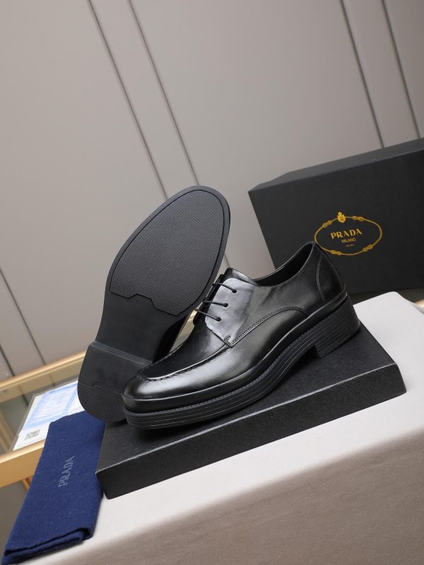Prada black leather lace-up derby shoes.