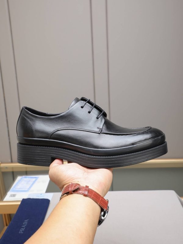 Prada black leather lace-up derby shoes.