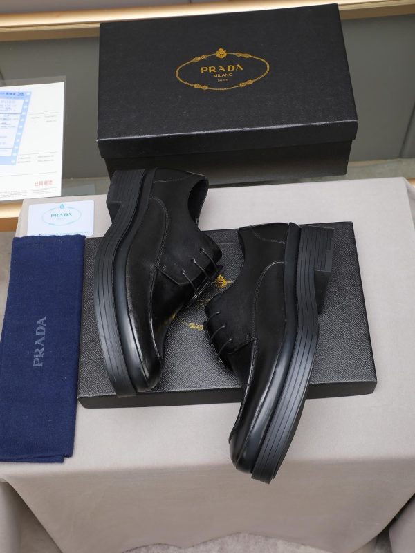 Prada black leather lace-up derby shoes.
