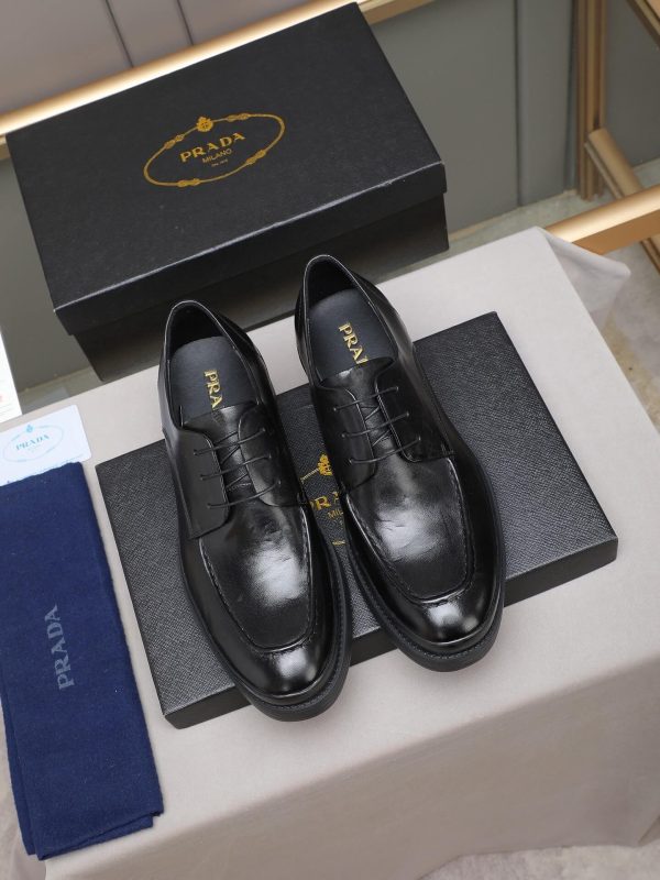 Prada black leather lace-up derby shoes.