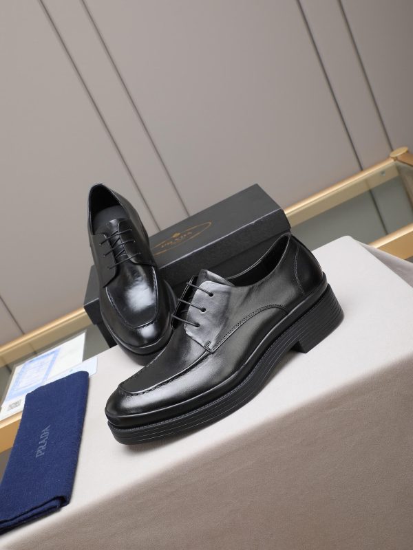 Prada black leather lace-up derby shoes.