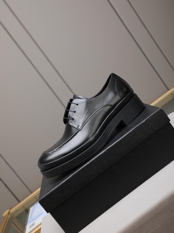 Prada black leather lace-up derby shoes.