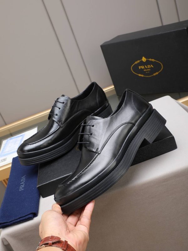Prada black leather lace-up derby shoes.