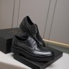 Prada black leather lace-up derby shoes.