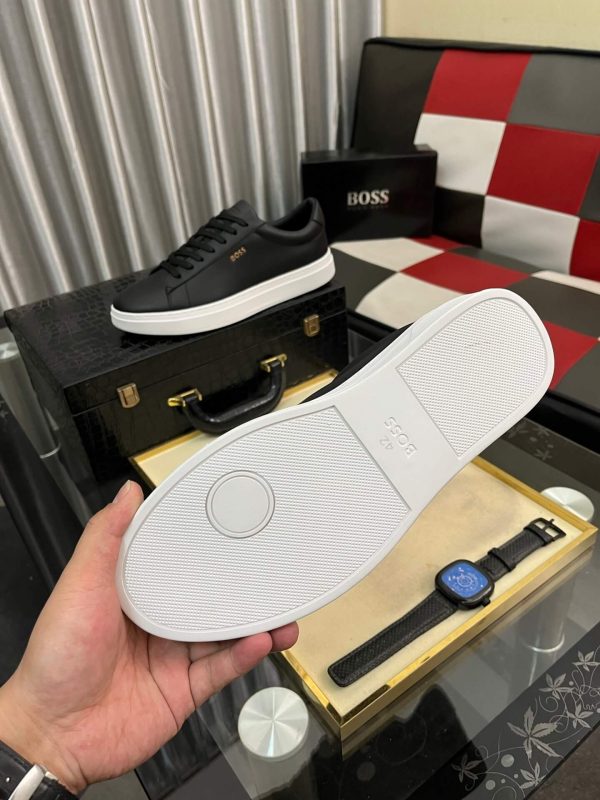 BOSS brown leather slip-on sneakers.