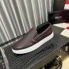 BOSS brown leather slip-on sneakers.