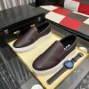BOSS brown leather slip-on sneakers.