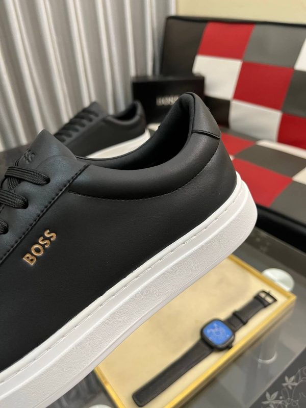 BOSS brown leather slip-on sneakers.