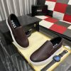BOSS brown leather slip-on sneakers.
