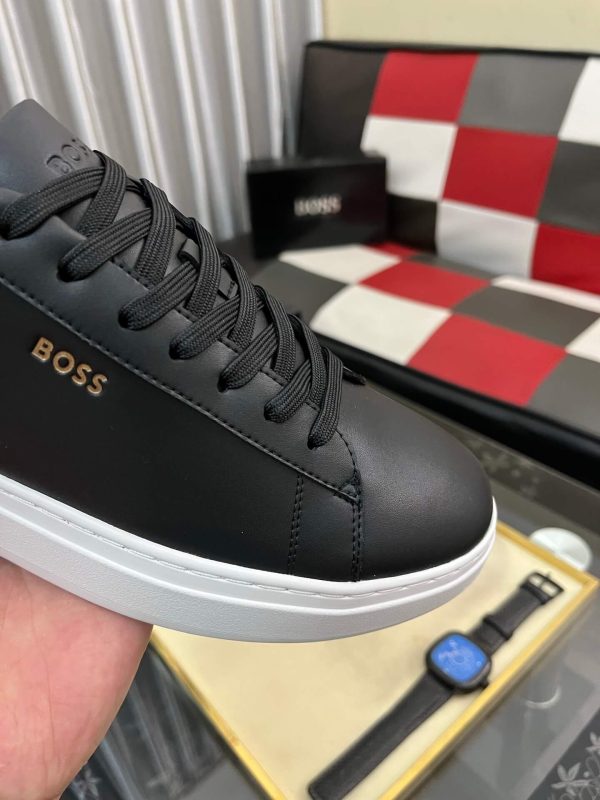 BOSS brown leather slip-on sneakers.