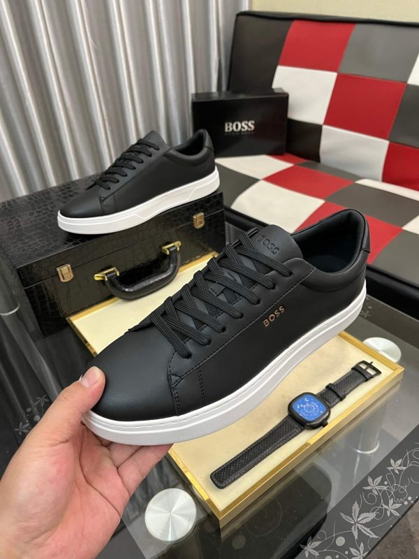 BOSS brown leather slip-on sneakers.