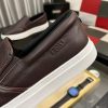 BOSS brown leather slip-on sneakers.