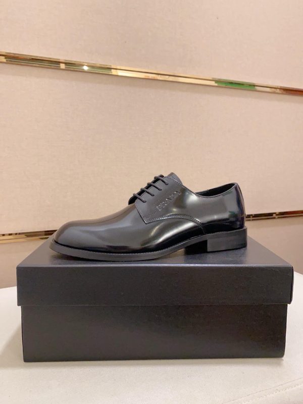 black Prada leather derby dress shoes.