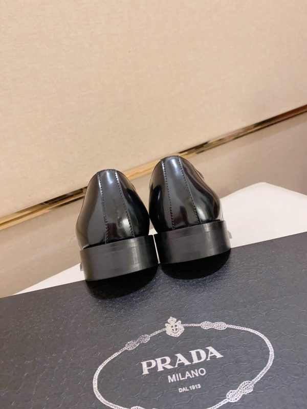 black Prada leather derby dress shoes.