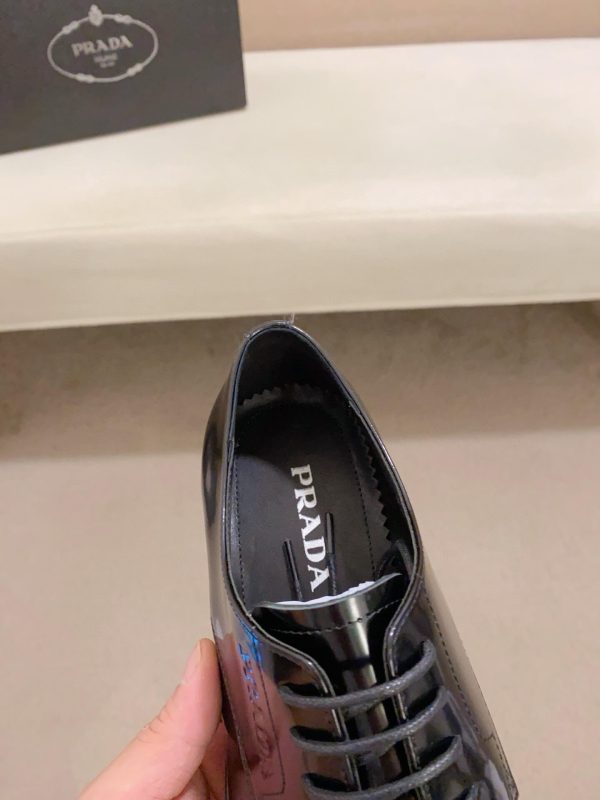 black Prada leather derby dress shoes.