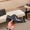 black Prada leather derby dress shoes.
