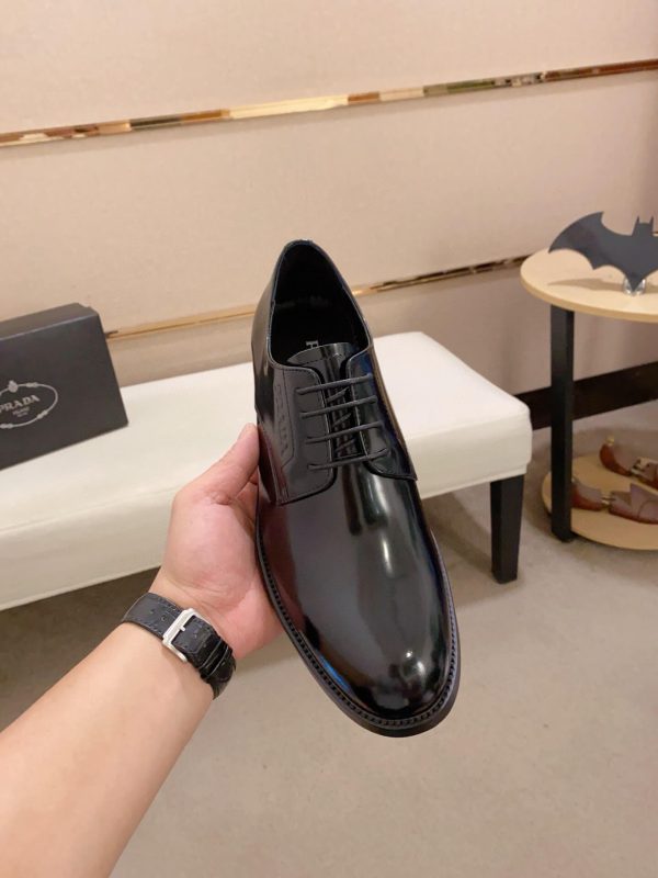 black Prada leather derby dress shoes.