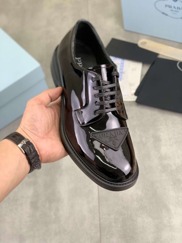 Prada black patent-leather derby shoe.