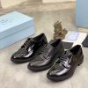 Prada black patent-leather derby shoe.