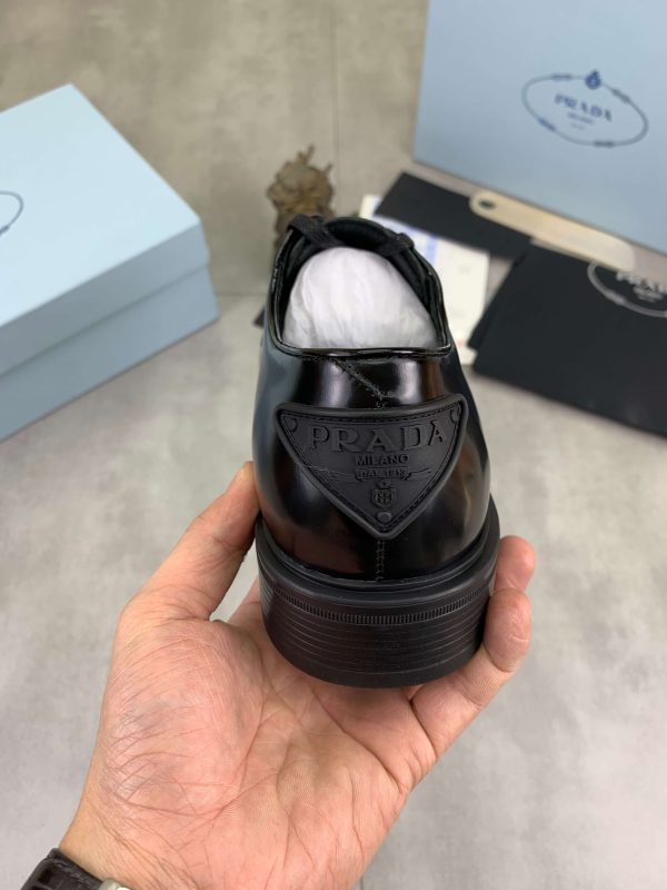 Prada black patent-leather derby shoe.
