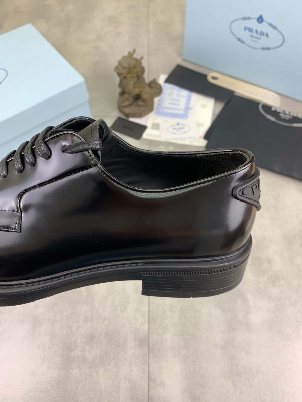 Prada black patent-leather derby shoe.