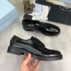 Prada black patent-leather derby shoe.