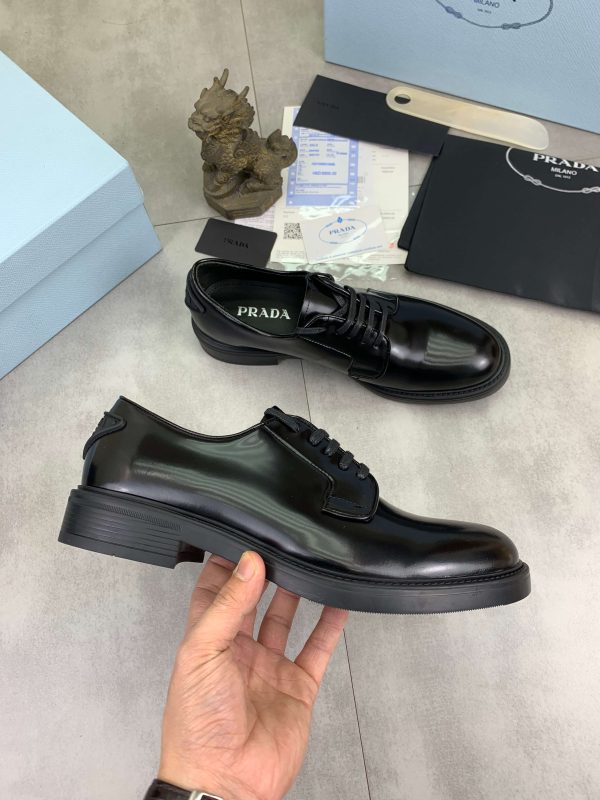 Prada black patent-leather derby shoe.