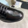 Prada black patent-leather derby shoe.