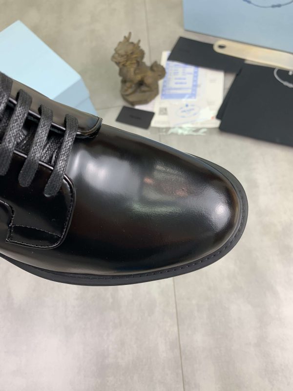 Prada black patent-leather derby shoe.
