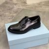Prada black patent-leather derby shoe.