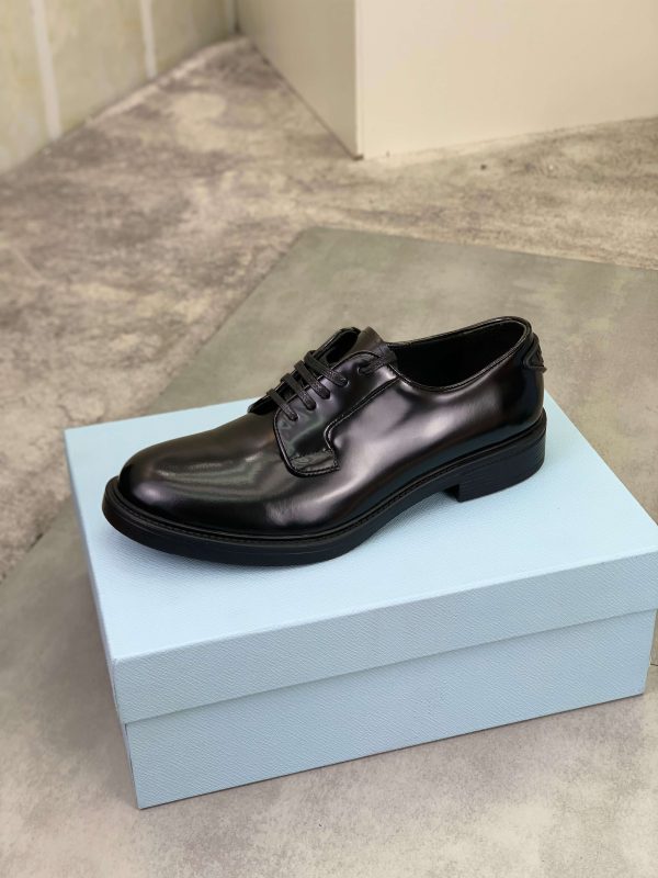 Prada black patent-leather derby shoe.