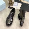 Prada black patent-leather derby shoe.