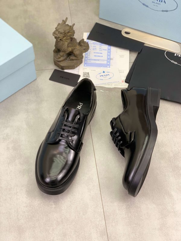 Prada black patent-leather derby shoe.
